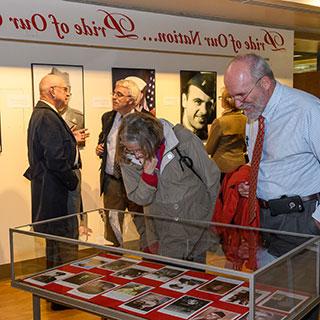 Visitors looking at exhibit in library atrium